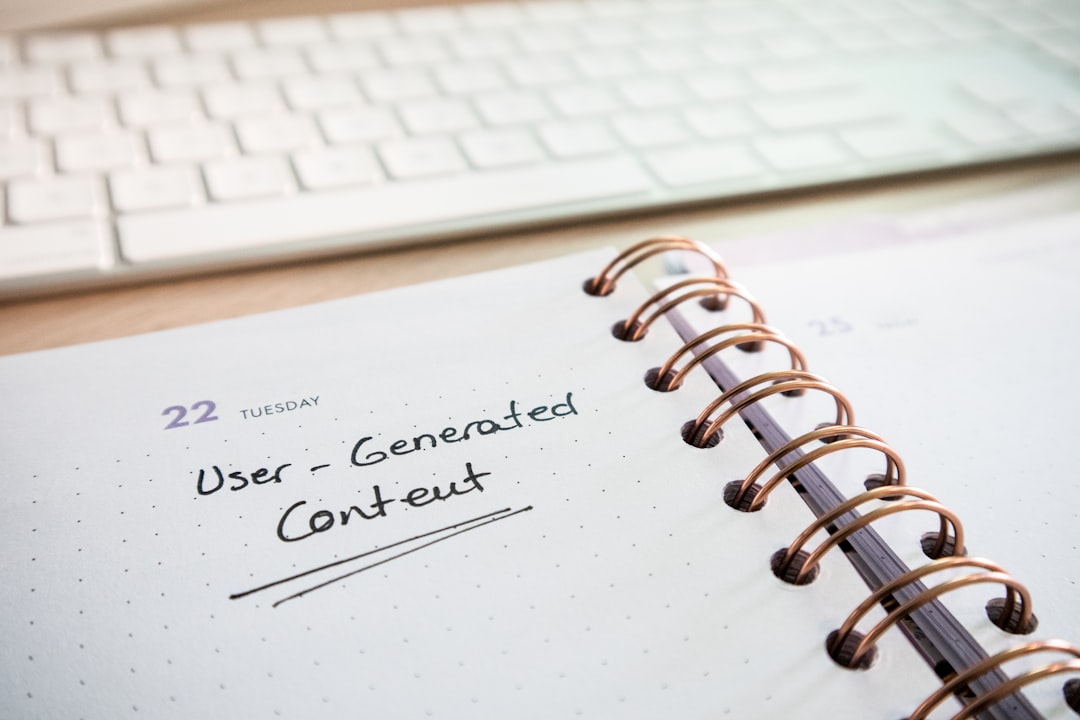 Desk with a keyboard and a planner with the words User-Generated Content on it